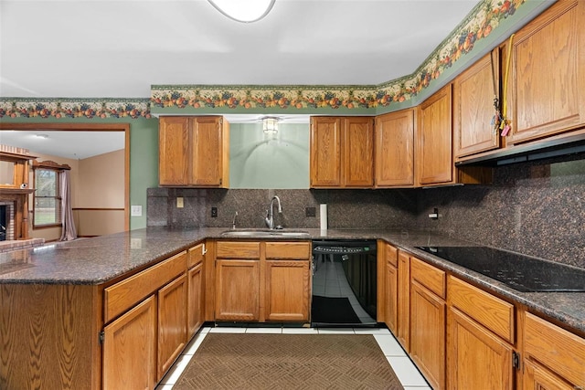 kitchen featuring light tile patterned flooring, sink, kitchen peninsula, decorative backsplash, and black appliances