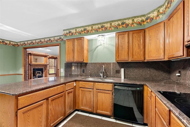 kitchen featuring sink, light tile patterned floors, backsplash, black appliances, and kitchen peninsula