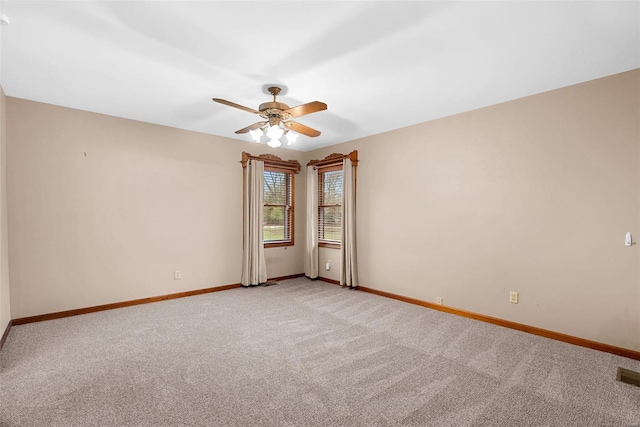 spare room featuring ceiling fan and light carpet