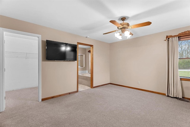 interior space featuring light carpet and ceiling fan