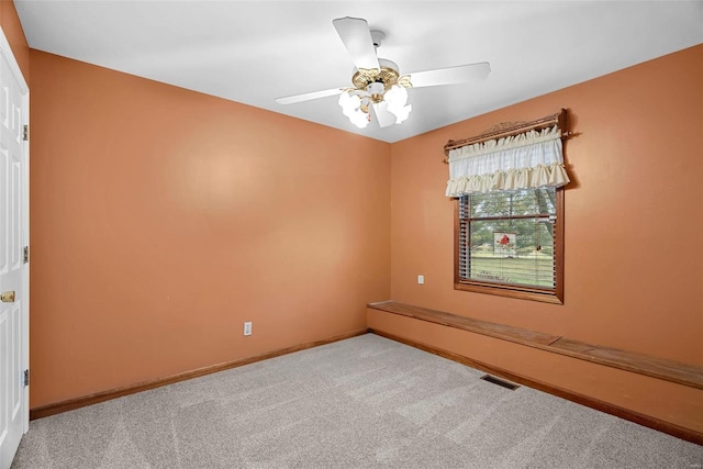 carpeted empty room with ceiling fan