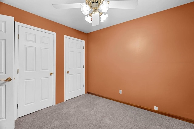 unfurnished bedroom featuring ceiling fan and light carpet