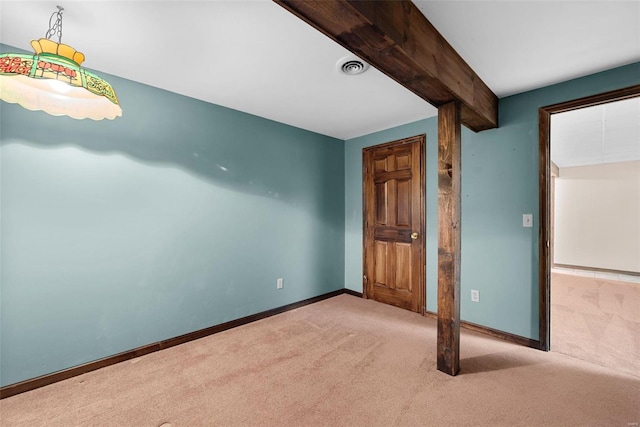 unfurnished bedroom featuring beamed ceiling and light carpet