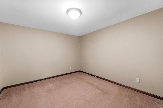 unfurnished room featuring light colored carpet