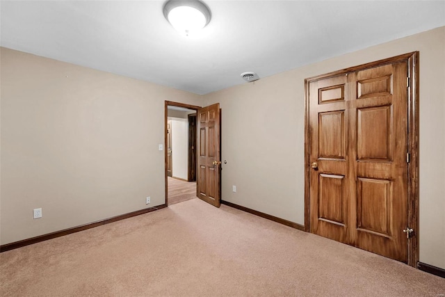 unfurnished bedroom featuring light carpet