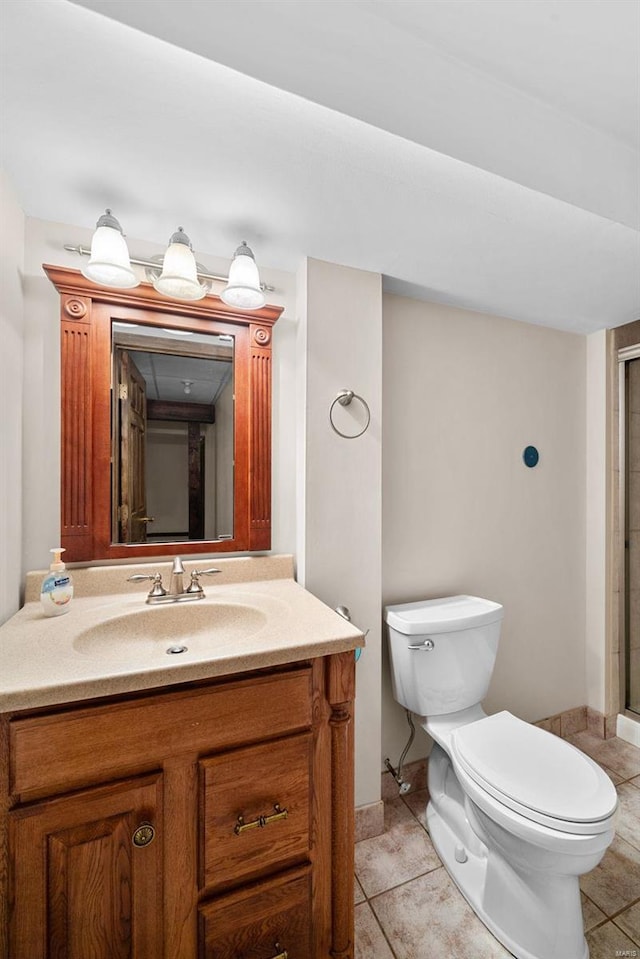 bathroom with vanity, tile patterned floors, and toilet