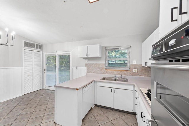 kitchen with white cabinetry, sink, light tile patterned floors, and white appliances