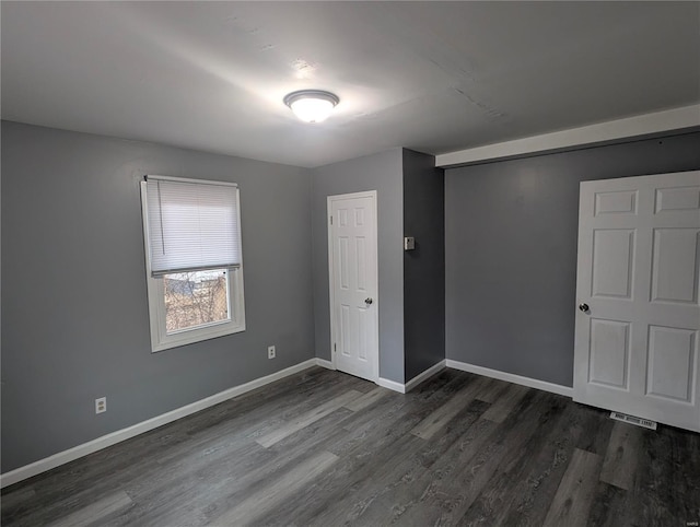 unfurnished bedroom featuring dark wood-type flooring