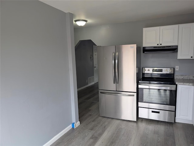 kitchen featuring light wood-type flooring, white cabinets, and appliances with stainless steel finishes