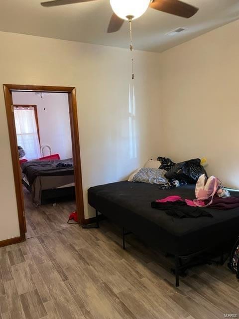 bedroom with hardwood / wood-style floors and ceiling fan