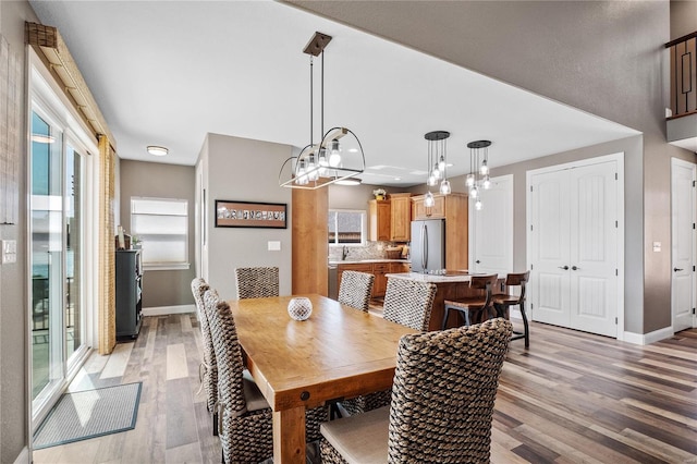 dining space with light hardwood / wood-style floors