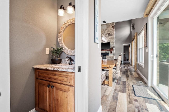 hallway with sink and light hardwood / wood-style flooring