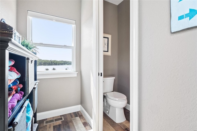 bathroom featuring hardwood / wood-style floors and toilet