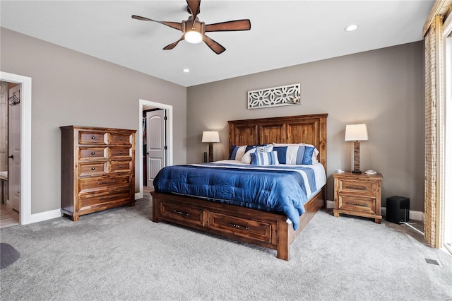 carpeted bedroom featuring ceiling fan and ensuite bath