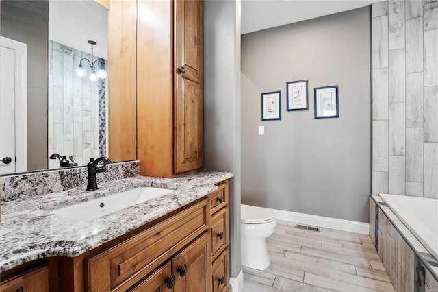 bathroom featuring vanity and toilet