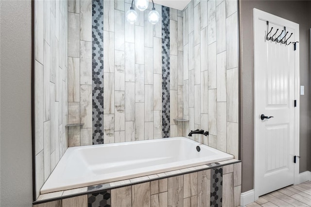 bathroom featuring tiled bath