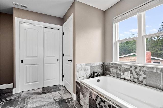 bathroom with tiled bath