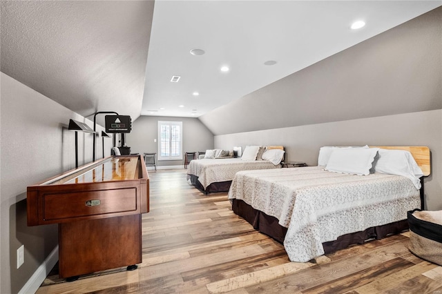 bedroom featuring light hardwood / wood-style flooring and vaulted ceiling