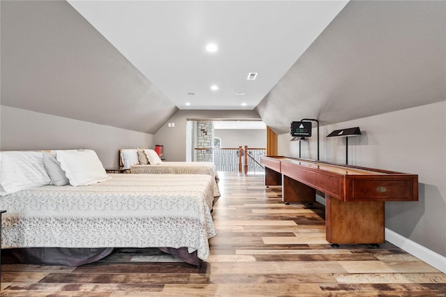 bedroom featuring vaulted ceiling and light hardwood / wood-style floors