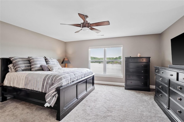 bedroom with ceiling fan and light colored carpet