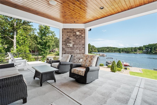 view of patio with a water view and outdoor lounge area