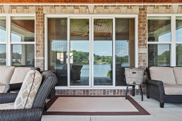 view of patio with a water view and an outdoor hangout area