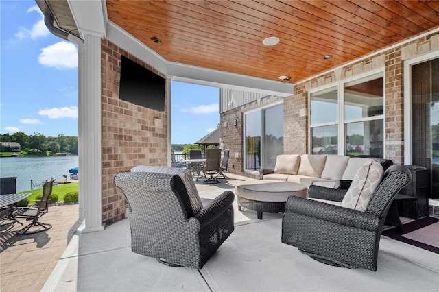 view of patio / terrace with an outdoor living space and a water view