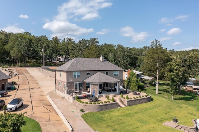 rear view of house with an outdoor hangout area, a yard, a patio area, and a gazebo