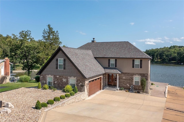 view of front of home featuring a garage and a water view