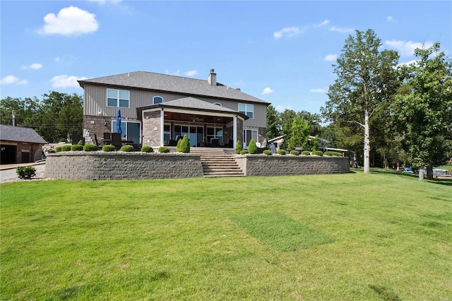 rear view of property featuring a yard