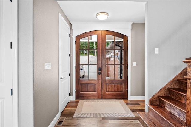 entryway with french doors and dark hardwood / wood-style flooring