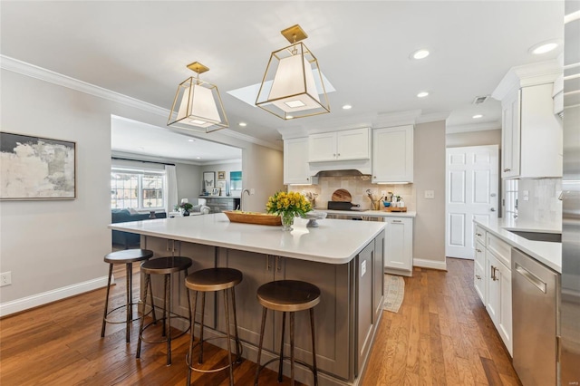 kitchen featuring light countertops, hanging light fixtures, dishwasher, and white cabinetry