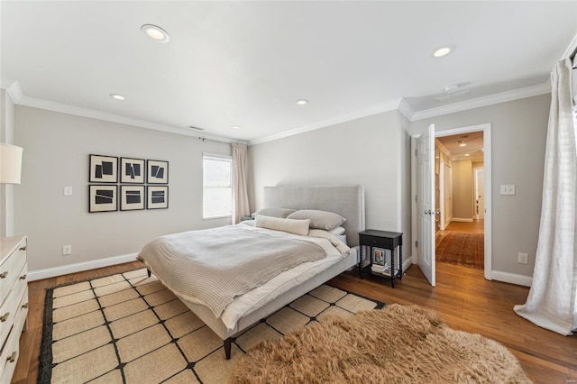 bedroom featuring recessed lighting, crown molding, baseboards, and wood finished floors