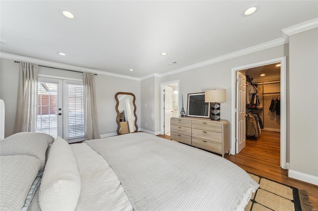 bedroom with wood finished floors, baseboards, access to outside, ornamental molding, and french doors