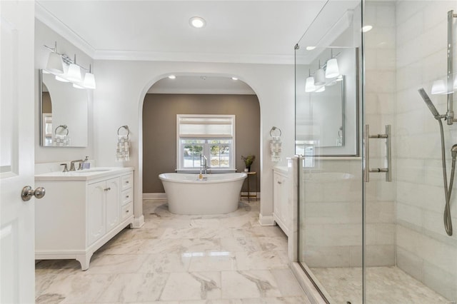 full bathroom with marble finish floor, ornamental molding, a freestanding tub, and vanity