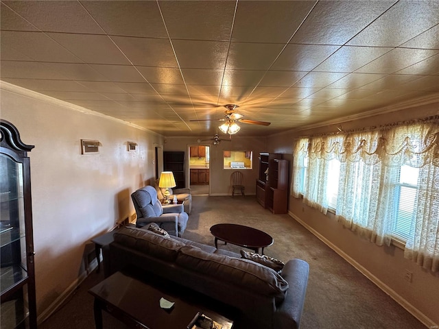 living room with crown molding, ceiling fan, and carpet