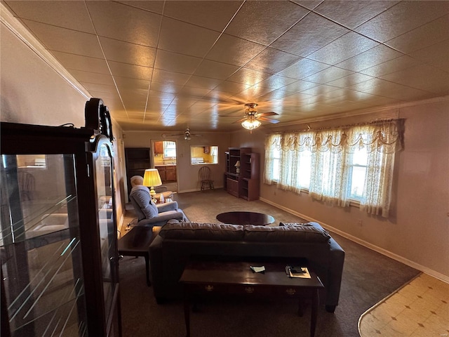 carpeted living room with ornamental molding and ceiling fan