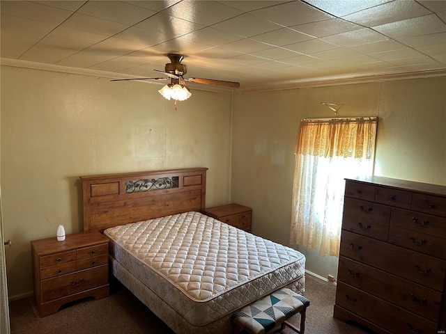 carpeted bedroom featuring crown molding and ceiling fan