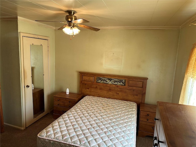 carpeted bedroom with ornamental molding and ceiling fan