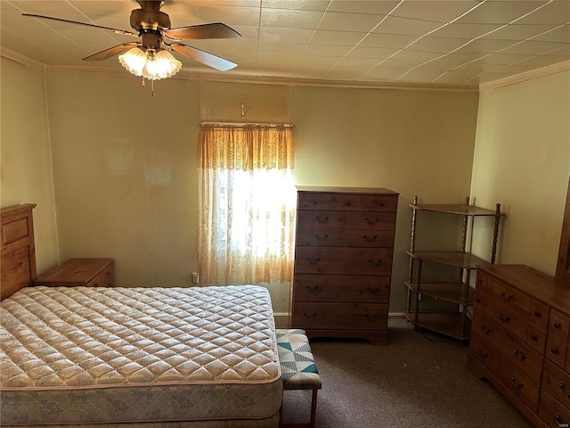 carpeted bedroom with ceiling fan and ornamental molding