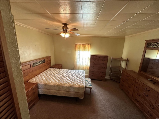 carpeted bedroom featuring crown molding and ceiling fan