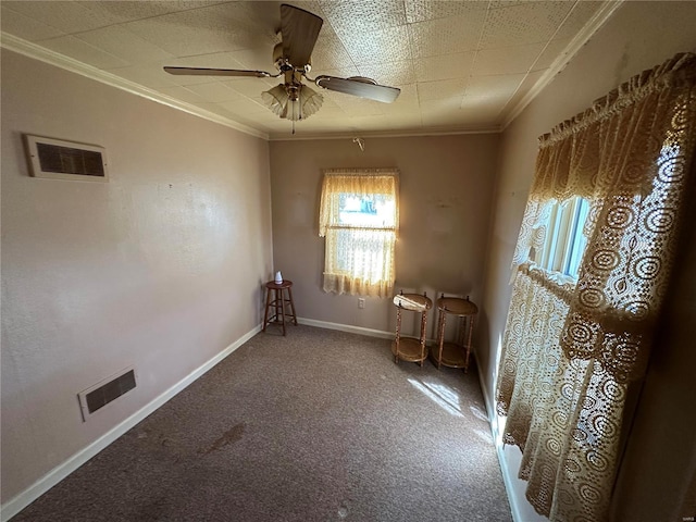 spare room featuring ornamental molding, carpet floors, and ceiling fan