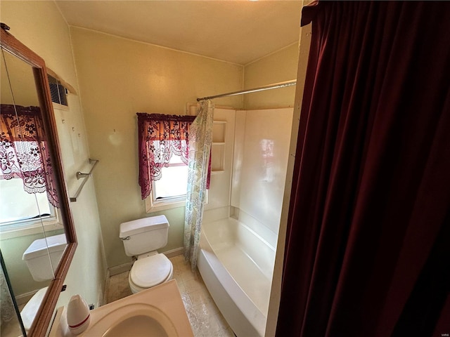 bathroom featuring tile patterned flooring, toilet, and shower / bath combo with shower curtain