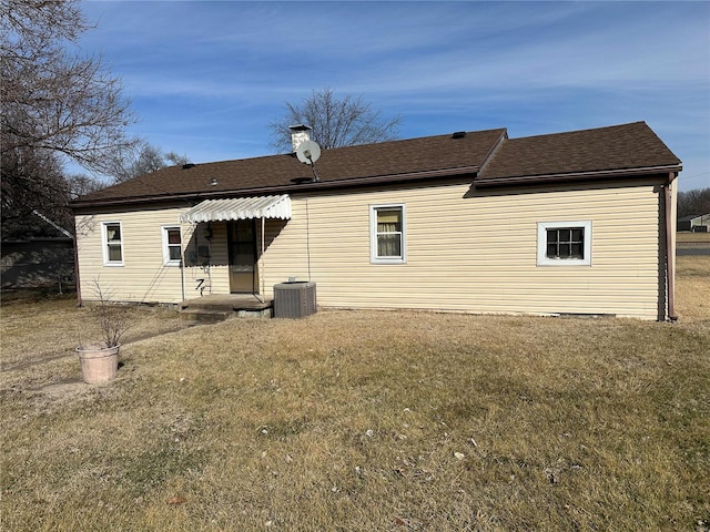 back of house featuring cooling unit and a lawn