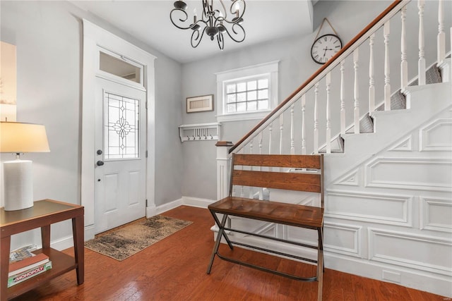 entryway with an inviting chandelier and wood-type flooring