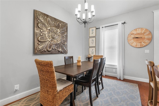 dining area featuring an inviting chandelier and hardwood / wood-style floors