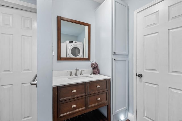 bathroom with vanity and washer / dryer