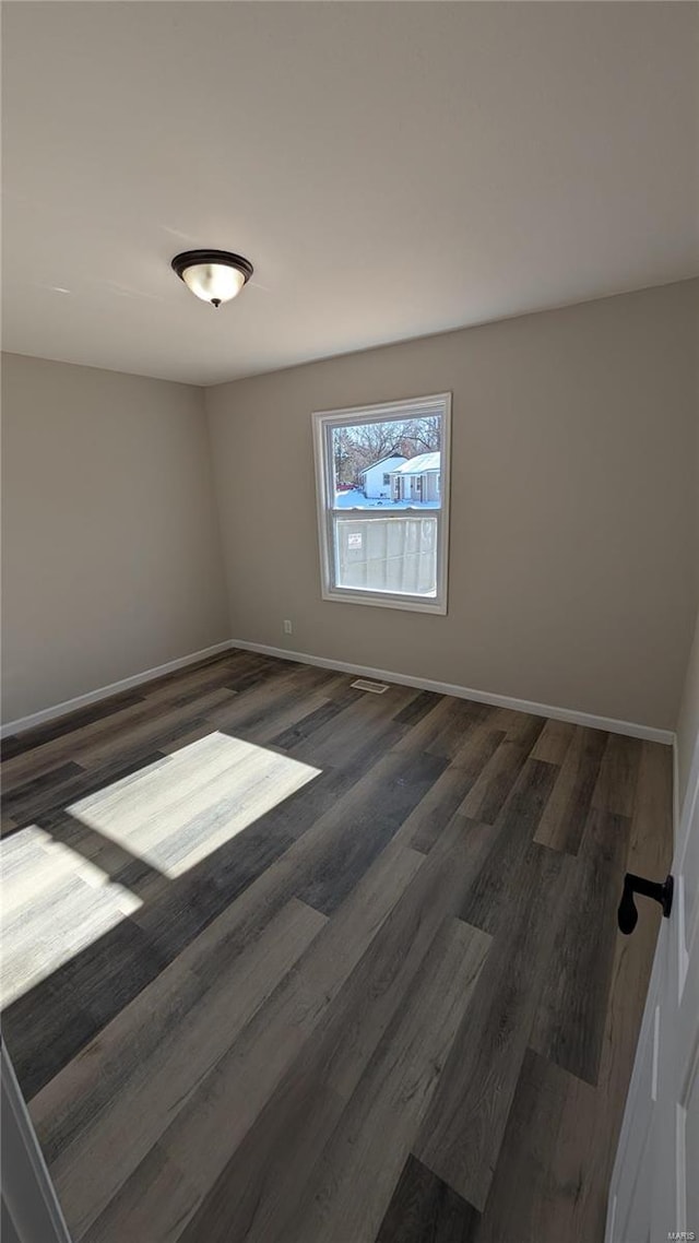 empty room featuring dark hardwood / wood-style floors