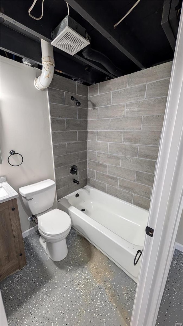 full bathroom with vanity, tiled shower / bath combo, and toilet