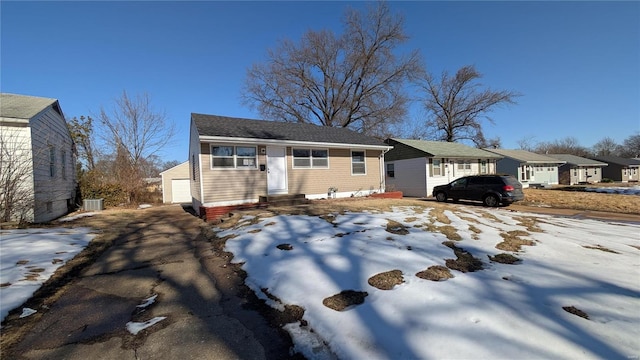 view of front of house with a garage and central AC